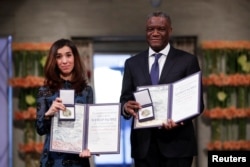 The Peace Prize laureates Iraqi Nadia Murad and Congolese doctor Denis Mukwege receive the Nobel Peace Prize for their efforts to end the use of sexual violence as a weapon of war and armed conflict at the Nobel Peace Prize Ceremony in Oslo Town Hall in Oslo, Norway, Dec. 10, 2018.