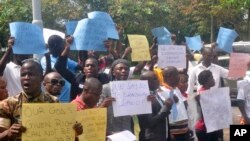 FILE - Liberians stage a protest outside the National Assembly against the government not doing enough to fight Ebola virus in Monrovia, Liberia, Oct. 9, 2014.