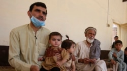 In this May 6, 2020 photo, Tariq Nawaz holds his 10-month-old baby daughter Tuba who suffers from polio, in Suleiman Khel, Pakistan. (AP Photo/Muhammad Sajjad)