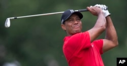 Tiger Woods watches his shot from the third tee during the final round of the Wyndham Championship golf tournament at Sedgefield Country Club in Greensboro, N.C., Aug. 23, 2015.