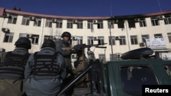 Afghan police keep watch near the Kabul traffic police headquarters that was attacked by insurgents, in Kabul, Afghanistan, January 21, 2013.