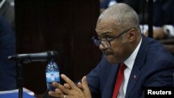 Haiti's Jack Guy Lafontant gestures during a meeting with members of the Parliament in Port-au-Prince, July 14, 2018. He resigned after days of protest over planned fuel price hikes. 