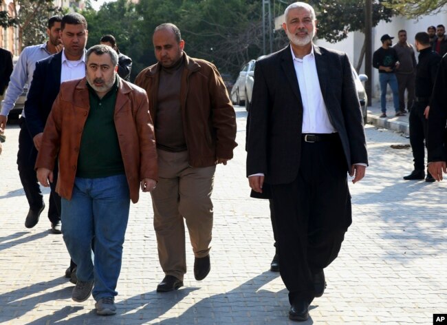 Hamas' supreme leader, Ismail Haniyeh, center right, tours destroyed buildings, in Gaza City, March 27, 2019. Haniyeh made his first public appearance since a new round of cross-border violence with Israel this week.