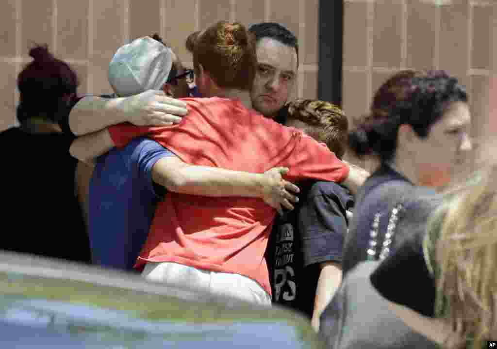 People react outside the unification center at the Alamo Gym, following a shooting at Santa Fe High School in Santa Fe, Texas.