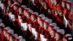 North Korean cheerleaders sing in unison before the opening ceremony of the 2018 Winter Olympics in Pyeongchang, South Korea, Friday, Feb. 9, 2018.