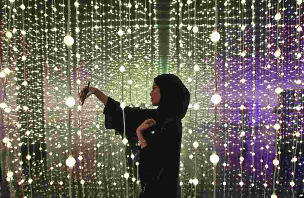 A woman takes a selfie at the Museum of the Future of the World Government Summit in Dubai, United Arab Emirates.