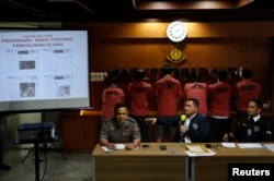 National Police Cyber Crime Director Brig. Gen. Fadil Imran (C), gestures in front of suspects arrested for cyber-crime related hoaxes on social media during a press conference in Jakarta, Indonesia, Feb. 28, 2018.