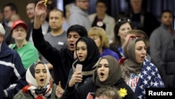 FILE - Young Muslims protest U.S. Republican presidential candidate Donald Trump before they were escorted out during a campaign rally in Wichita, Kansas, March 5, 2016.