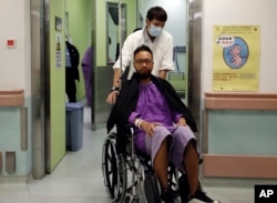 Ken Tsang, a member of a local pro-democracy political party, is admitted at a hospital for a medical exam after sustaining injuries during a clash between protesters and police in an occupied area near government headquarters in Hong Kong, Oct. 15, 2014.