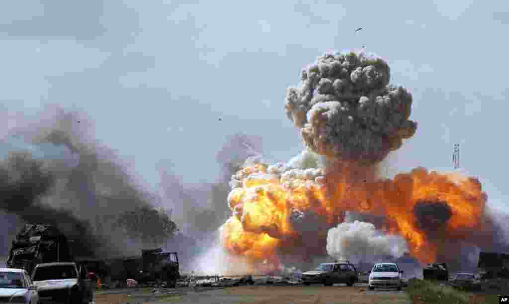 Vehicles belonging to forces loyal to Libyan leader Moammar Gadhafi explode after an air strike by coalition forces, along a road between Benghazi and Ajdabiyah, March 20, 2011. (Reuters)
