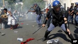 Students run for cover as police fire stun grenades and rubber bullets in an attempt to disperse them, during their protest for free education in Johannesburg, South Africa, Sept. 21, 2016. 