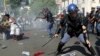 Students run for cover as police fire stun grenades and rubber bullets in an attempt to disperse them, during their protest for free education in Johannesburg, South Africa, Sept. 21, 2016. 