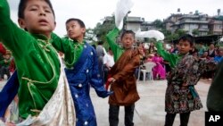 Tibetan boys dance during celebrations to mark the 82nd birthday of their spiritual leader the Dalai Lama at a Tibetan camp in Lalitpur, Nepal, July 6, 2017.