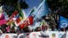 Public sector workers hold unions flags during a demonstration in Marseilles, southern France, May 9, 2019.