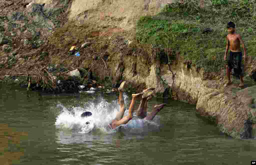 Children bathe in a creek in Naypyitaw, Myanmar. 