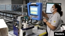Una empleada de Hamilton Medical, en Suiza, hace pruebas a un respirador o pulmón artificial en su fábrica de Domat.