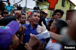 Venezuelan presidential candidate Henri Falcon of the Avanzada Progresista party, greets supporters during a campaign rally in Caracas, Venezuela, May 14, 2018.