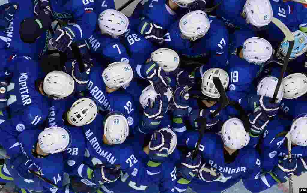 Slovenia&#39;s players celebrate at the end of the Men&#39;s Ice Hockey Group A match Slovakia vs Slovenia at the Bolshoy Ice Dome during the Sochi Winter Olympics in Russia. Slovenia won 1-3.