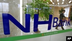 A customer leaves a branch of the Nonghyup bank in Seoul, South Korea,May 3, 2011.