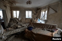A house damaged by recent shelling is seen in Novoluhanske, Ukraine, Dec. 19, 2017.