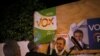 Members of Spain's far-right party VOX put up a campaign poster, while main candidates for Spanish general elections debate during a live televised debate ahead of general elections in Madrid, outside a polling station in Ronda, Spain April 22, 2019.