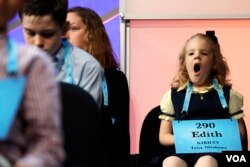Edith Fuller, 6, of Tulsa, Okla., the youngest speller in history to compete in the bee, yawns as she waits to compete in the 90th Scripps National Spelling Bee in Oxon Hill, Maryland, Wednesday, May 31, 2017. She spelled her word correctly. (AP Photo/Jacquelyn Martin)