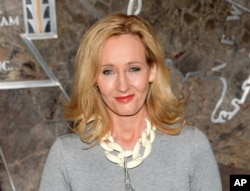 FILE - "Harry Potter" author J.K. Rowling lights the Empire State Building to mark the launch of her non-profit children's organization Lumos, in New York, April 9, 2015.