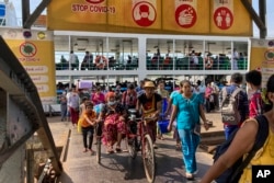 FILE - People disembark from a ferry at the Pansodan jetty in Yangon, Myanmar on Nov. 12, 2021.