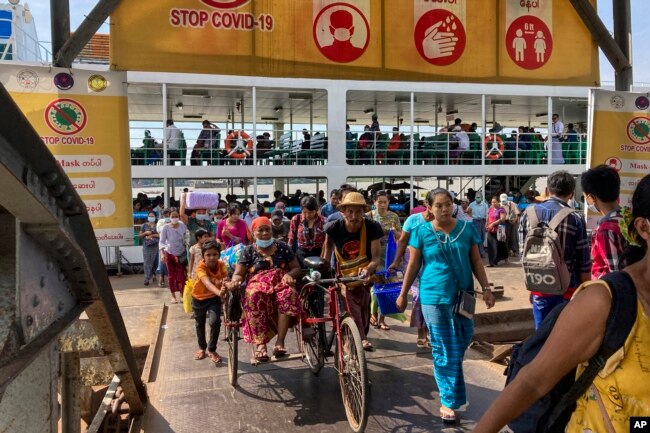 FILE - People disembark from a ferry at the Pansodan jetty in Yangon, Myanmar on Nov. 12, 2021.