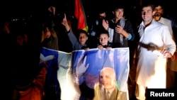Supporters of Afghan presidential candidate Ashraf Ghani celebrate on the street after he was named president-elect in Kabul, September 21, 2014.