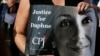 FILE - A person's placard depicts Daphne Caruana Galizia as people gather at the site where the journalist was assassinated a year earlier, in Bidnija, Malta, Oct. 16, 2018. At the time of her death, Galizia was facing 48 libel cases.