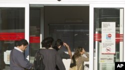 People enter an unemployment registration office in Madrid, September 4, 2012. 