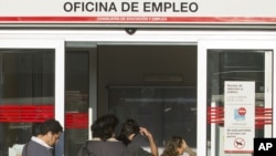 People enter an unemployment registration office in Madrid, September 4, 2012. 