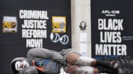A man sleeps on a bench in front of Black Lives Matter protest signs near the White House in Washington, U.S., June 10, 2020. REUTERS/Kevin Lamarque