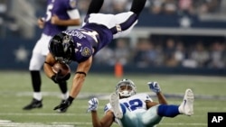 In the 2014 file photo, Baltimore Ravens' football player Kyle Juszczyk (44) goes flying after a collision in an NFL preseason football game. Football players can suffer from brain disorder after being hit in the head many times. (AP Photo/Brandon Wade)