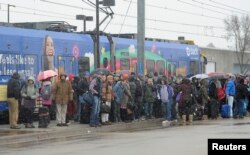 Travelers are stranded one stop short of the Minneapolis-St. Paul International Airport after a group of Black Lives Matter protesters shut down rail line to the airport following a protest at the Mall of America in Bloomington, Minnesota, Dec. 23, 2015.