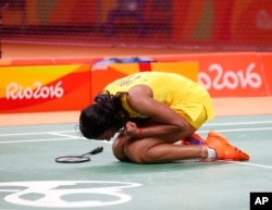 India's Sindhu Pusarla reacts after defeating China's Wang Yihan during the Women's Badminton Singles Quarterfinal at the 2016 Summer Olympics in Rio de Janeiro, Brazil, Aug. 16, 2016.