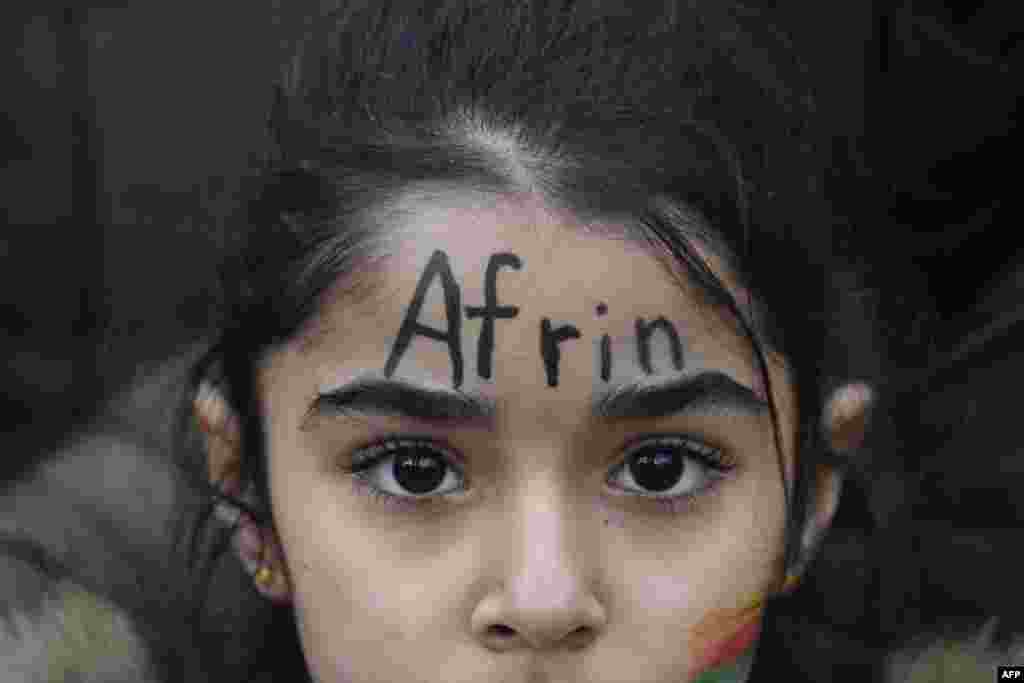 A young demonstrator with the word &#39;Afrin&#39; painted on his face takes part to a demonstration to protest against the ongoing Turkish military campaign in the Kurdish-held Syrian enclave of Afrin in front of the Turkish embassy in Berlin.
