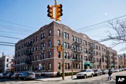 FILE - This March 15, 2018 photo shows apartment buildings in the Astoria section of Queens, N.Y.