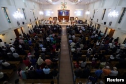 FILE - Worshippers attend their Friday evening Mass at Sacred Heart Catholic Church, as Catholics are awaiting a historic visit by Pope Francis to the United Arab Emirates, in Manama, Bahrain, Jan. 18, 2019.