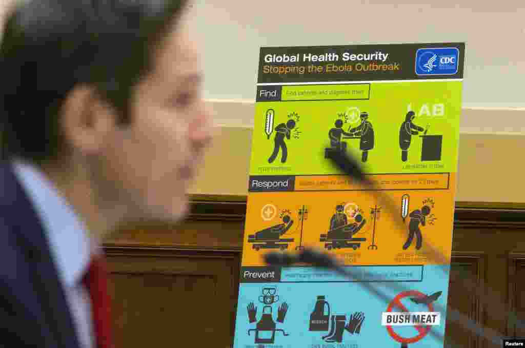 U.S. Centers for Disease Control and Prevention (CDC) Director Tom Frieden displays CDC educational materials as he testifies about the Ebola crisis in West Africa during a hearing of a House Foreign Affairs subcommittee on Capitol Hill, in Washington, DC, Aug. 7, 2014.