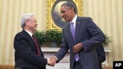 FILE - President Barack Obama, right, meets with Vietnamese Communist party secretary general Nguyen Phu Trong in the Oval Office of the White House, on July 7, 2015, in Washington. 