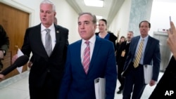 Rep. Steve Womack, R-Ark. (L) greets Veterans Affairs Secretary David Shulkin (C), as he arrives for a House Appropriations subcommittee hearing on Capitol Hill in Washington, March 15, 2018. 