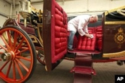 Carriage restorer Dave Evans cleans the 1902 State Landau coach at the Royal Mews in London March 21, 2011.