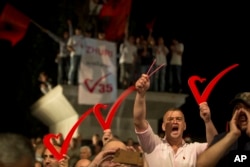 Supporters of the opposition party "Vetevendosje" hold heart signs during the closing election campaign rally in Kosovo capital Pristina, June 9, 2017.