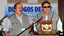 FILE - Jesus Santrich (R) of the Revolutionary Armed Forces of Colombia with fellow FARC member Andres Paris during peace talks in Havana.