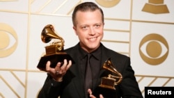 Jason Isbell holds the awards for Best Americana Album and Best American Roots Song during the 58th Grammy Awards in Los Angeles, Feb. 15, 2016. 