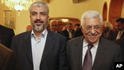 In this photo provided Nov. 24, 2011 by the office of Khaled Meshaal, Palestinian Hamas leader Khaled Mashaal, left, and Palestinian President Mahmoud Abbas are seen together during a meeting in Cairo, Egypt. 