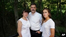 In this Aug. 9, 2017 photo family members of 18-year-old murder victim Andrew Oneschuk, stand for a portrait at their home in Wakefield, Mass. Devon Arthurs, co-founder of the neo-Nazi group Atomwaffen, was arrested on murder charges in the shooting death death of two roommates, including Oneschuk, in May of 2017. 