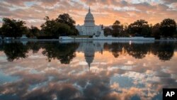 FILE - The Capitol at sunrise in Washington, Oct. 10, 2017. The crush of unfinished business facing lawmakers when they return to the Capitol this week would be daunting even if Washington were functioning at peak efficiency. 